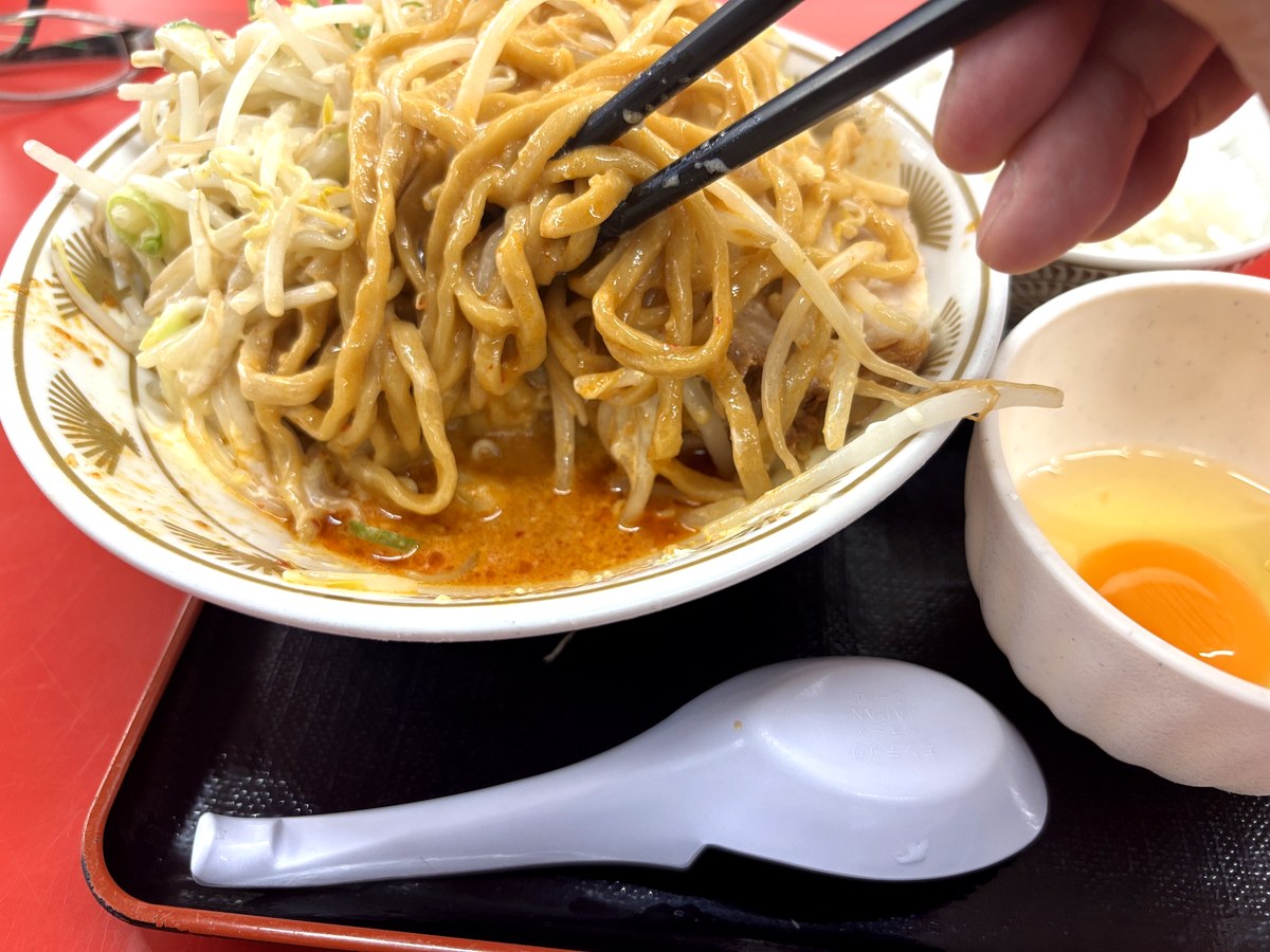 濃厚なタレが絡んだ油そばの極太麺
