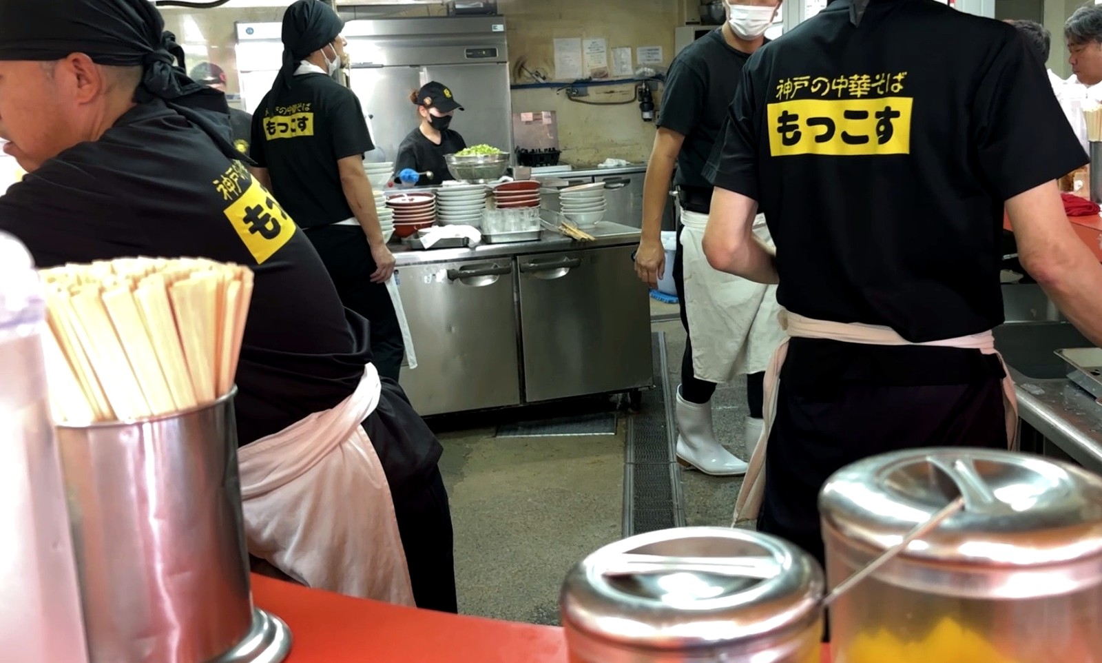 カウンター越しに見えるもっこす石屋川店の厨房と店員の様子